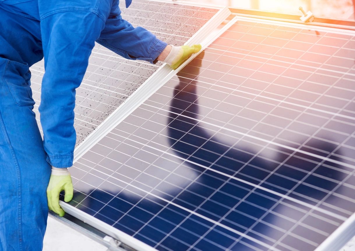 worker placing a solar panel